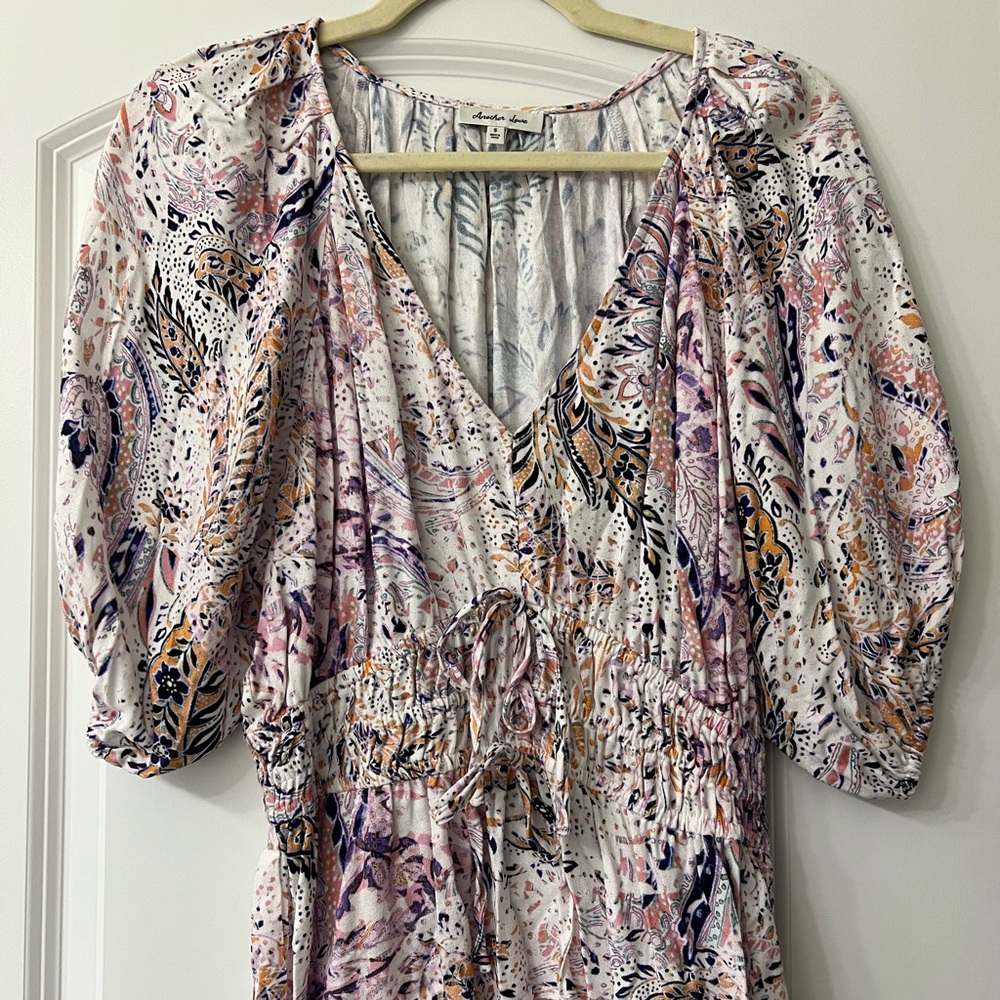 Size small never work paisley v neck top with puffy sleeves. Never worn.
